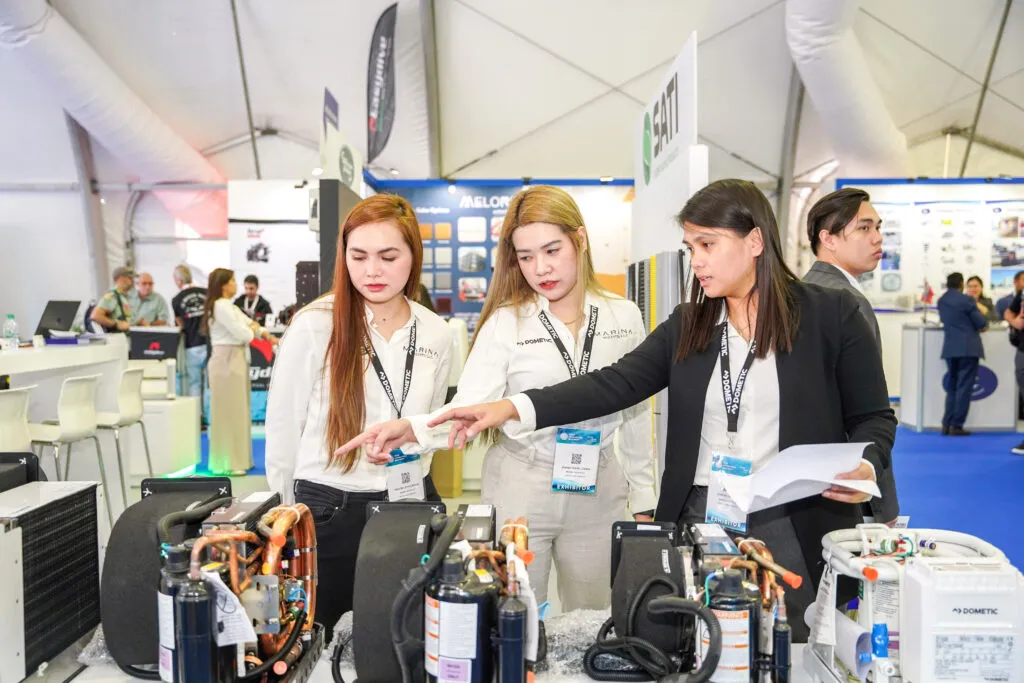 Exhibitor demonstrating Dometic marine equipment.
